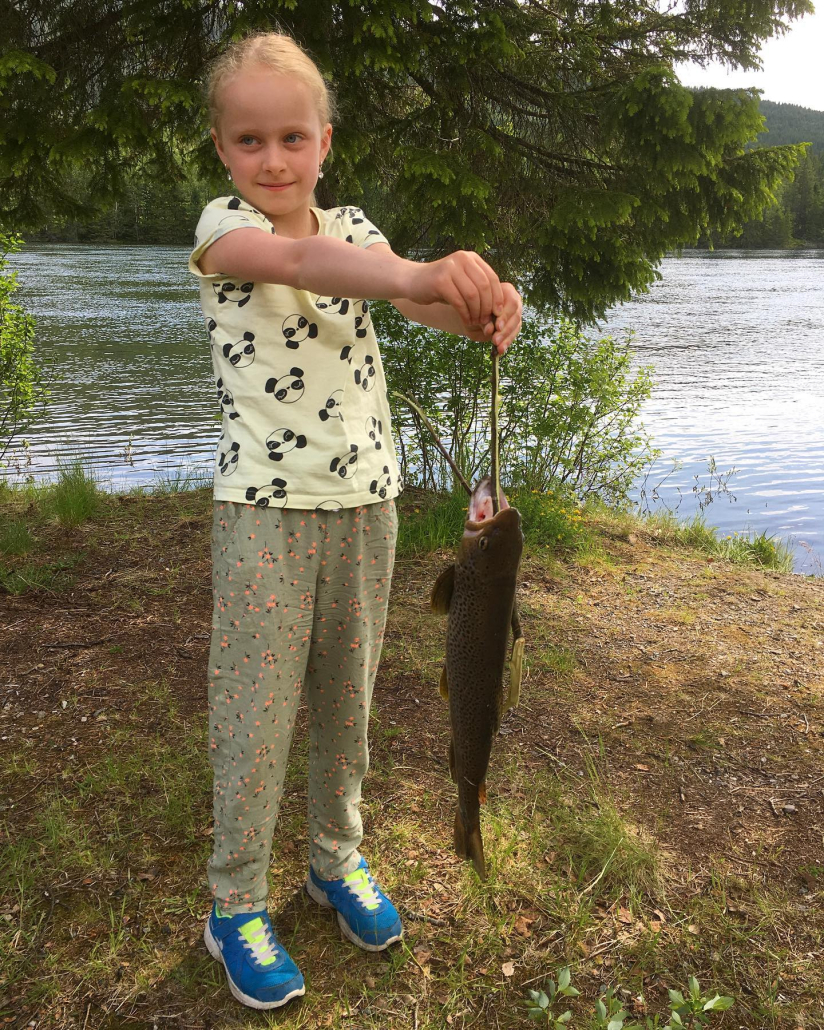 young girl with fish in hand