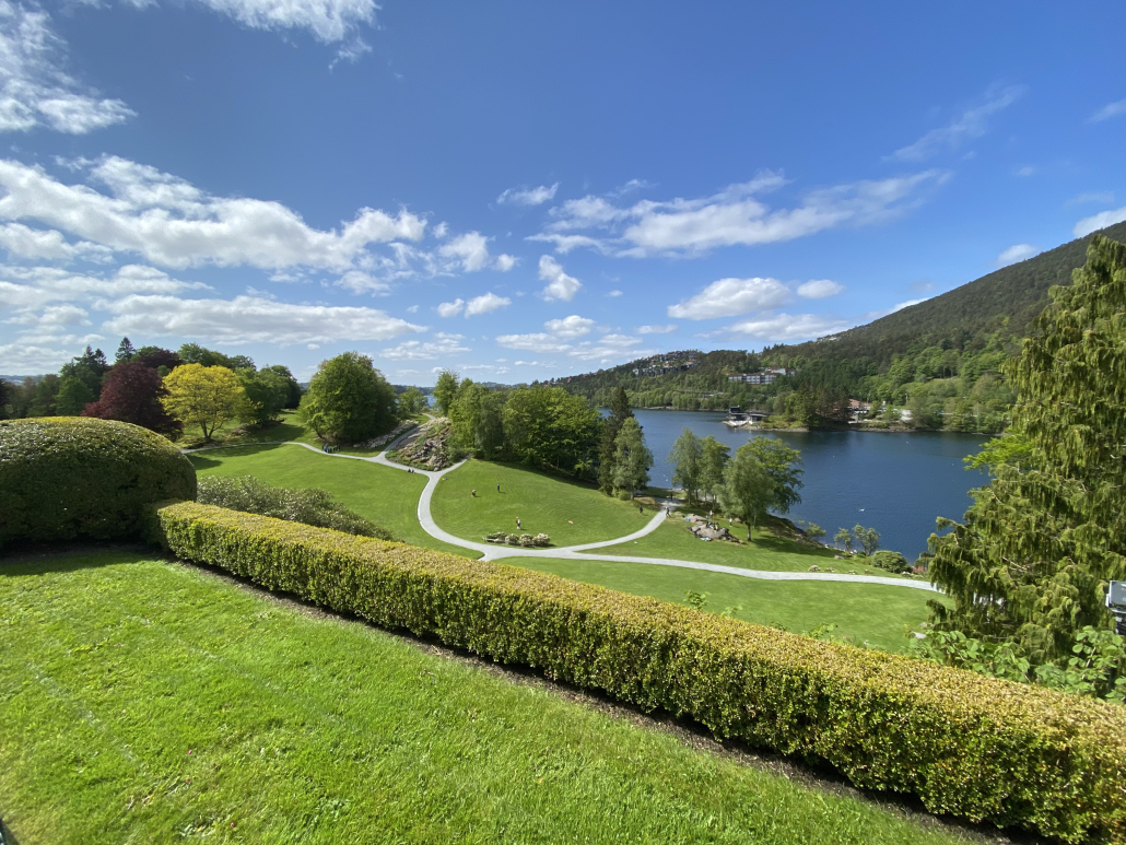 A private tour group enjoying the fjord view from the Havråtunet open-air museum near Bergen.